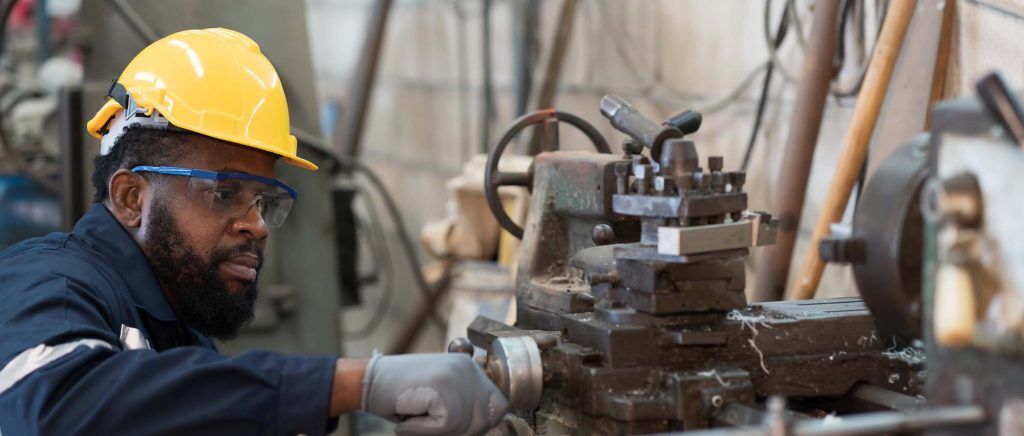 Male factory worker working at work maintenance machine