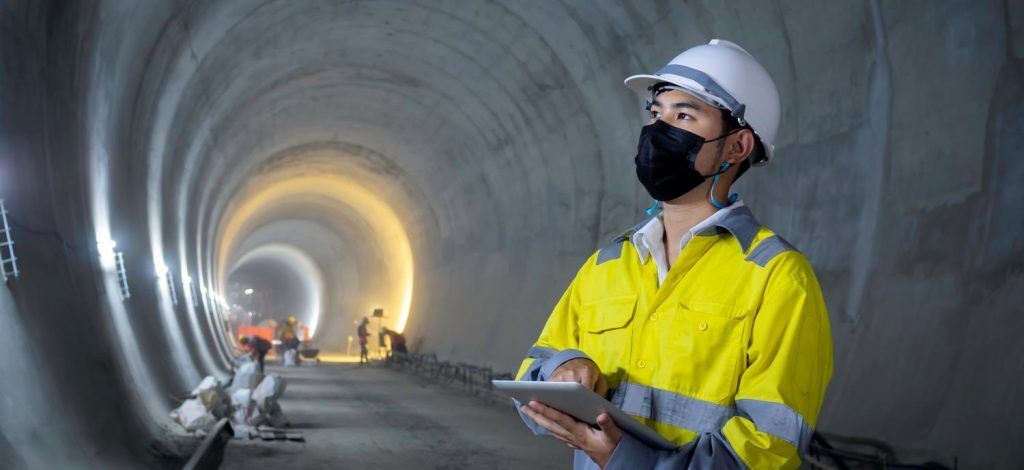 Young Asian tunnel engineering working at construction site.
