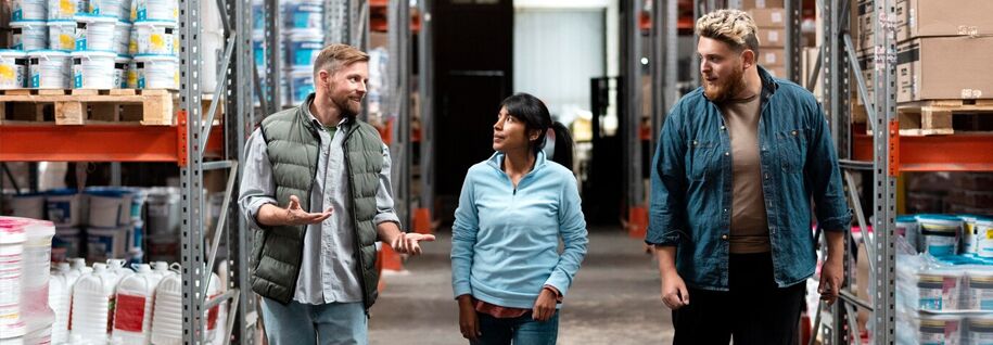 three colleagues discussing something during a warehouse round